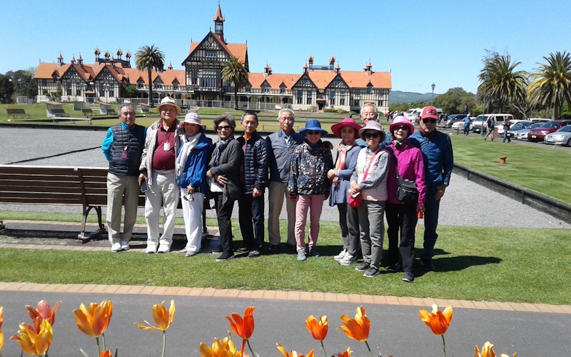 Tour group at Government Gardens, looking back to historc Bath-house