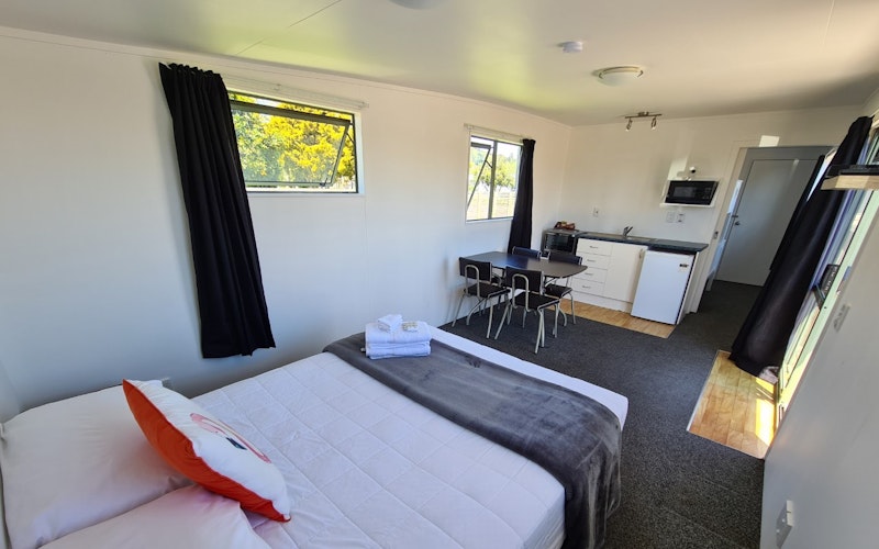Our Self-contained units have all that one will need for wee holiday.  Featuring a bed in the lounge, TV and table and chairs plus small kitchenette, a spare bed in the bedroom, and a bathroom.  