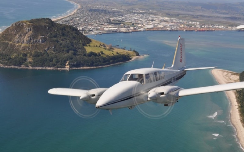 A Sunair scenic flight soars over Mauao (Mt Maunganui),Mount Main Beach and Tauranga Harbour